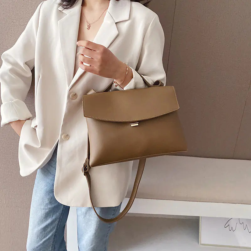 Woman using a leather shoulder bag