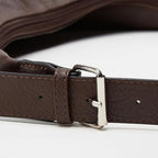 Leather belt with a silver buckle of a leather shoulder bag