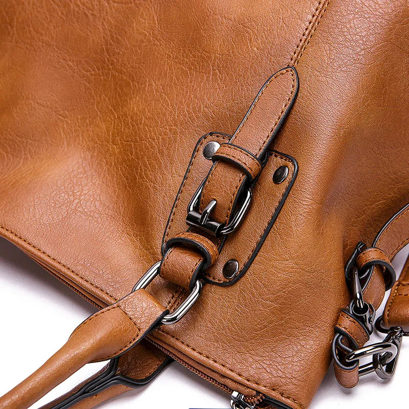 Leather handbag strap with metal buckle detail
