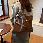 Woman wearing a brown leather shoulder bag