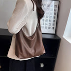 Woman wearing a brown leather shoulder bag 